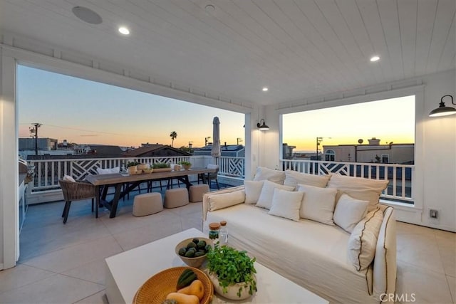 patio terrace at dusk featuring an outdoor living space