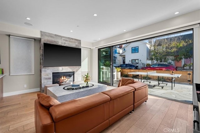 living room with a fireplace and light hardwood / wood-style floors