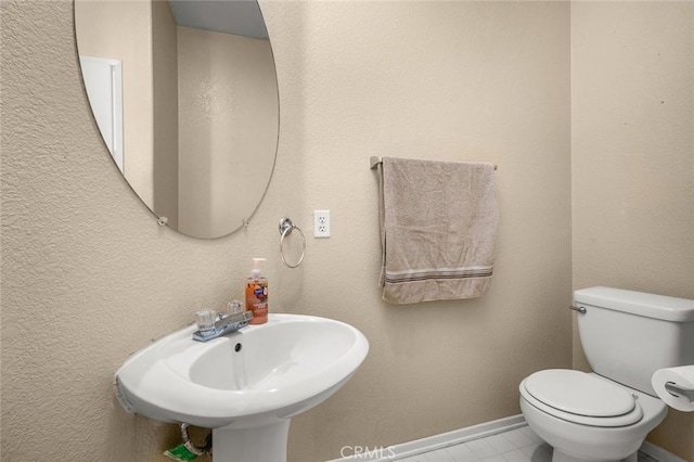 bathroom featuring sink and toilet