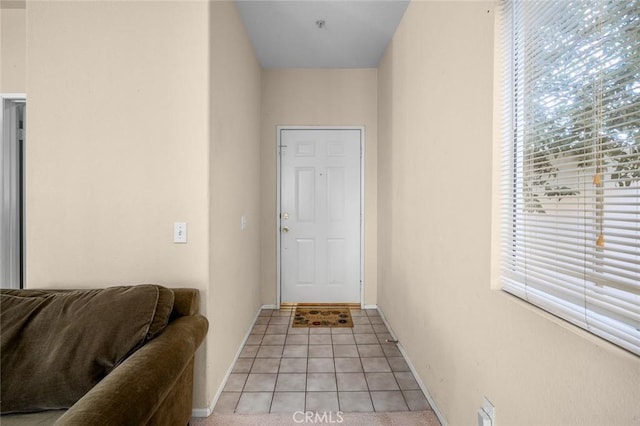 doorway featuring light tile patterned flooring