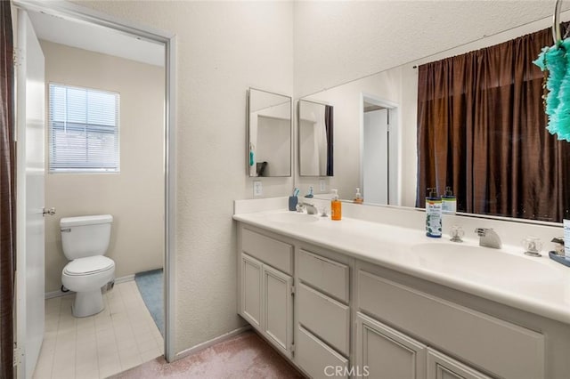 bathroom with toilet and vanity