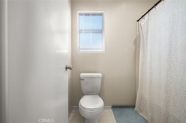 bathroom featuring toilet and a shower with shower curtain