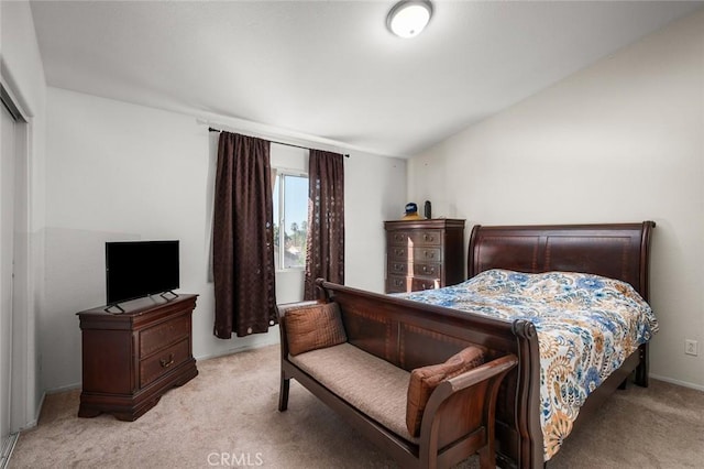 carpeted bedroom featuring lofted ceiling