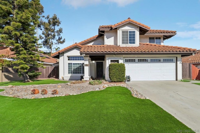 mediterranean / spanish-style home featuring a front lawn and a garage