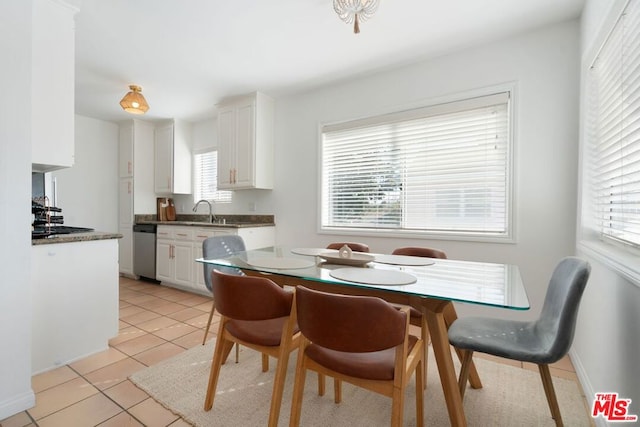 tiled dining space featuring sink