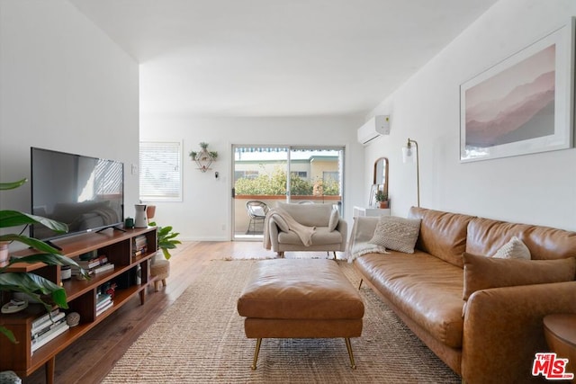 living room with hardwood / wood-style flooring and a wall mounted air conditioner