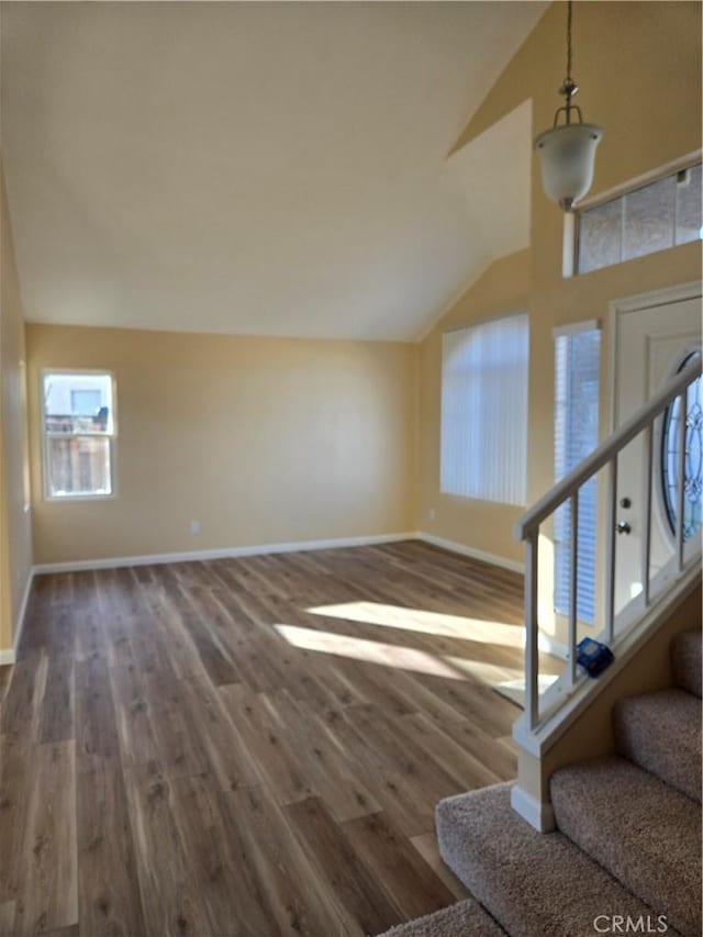 interior space with vaulted ceiling and wood-type flooring