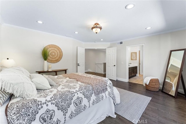 bedroom with ensuite bathroom, crown molding, and dark hardwood / wood-style floors