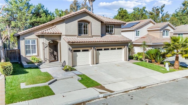 mediterranean / spanish home featuring a front lawn and a garage