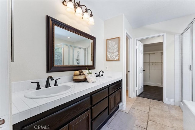 bathroom with walk in shower and vanity