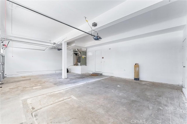 garage featuring heating unit and a garage door opener