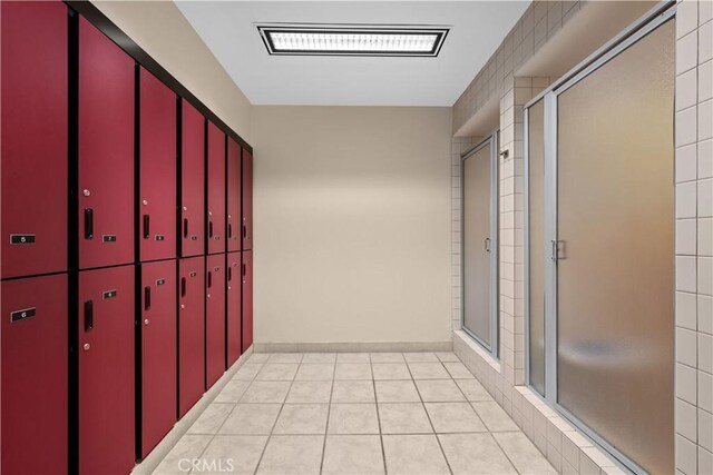 hall with light tile patterned floors