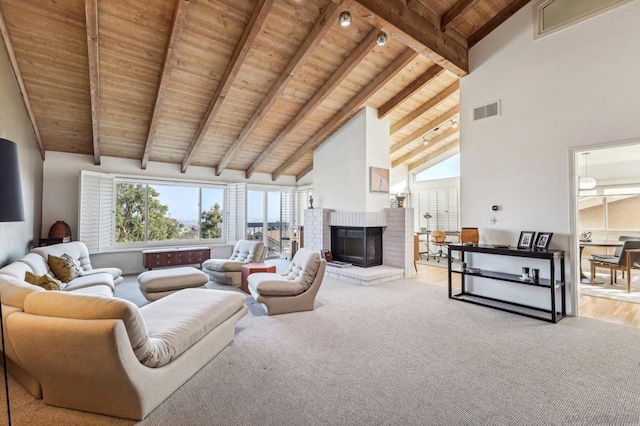 living room with high vaulted ceiling, a fireplace, beamed ceiling, and wooden ceiling