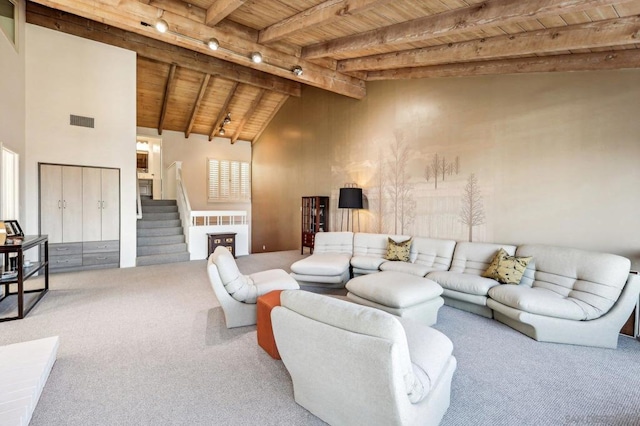 carpeted living room featuring wooden ceiling, track lighting, beam ceiling, and high vaulted ceiling