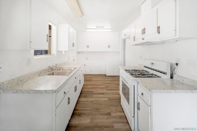 kitchen featuring white cabinetry, light hardwood / wood-style floors, white range with gas stovetop, and sink