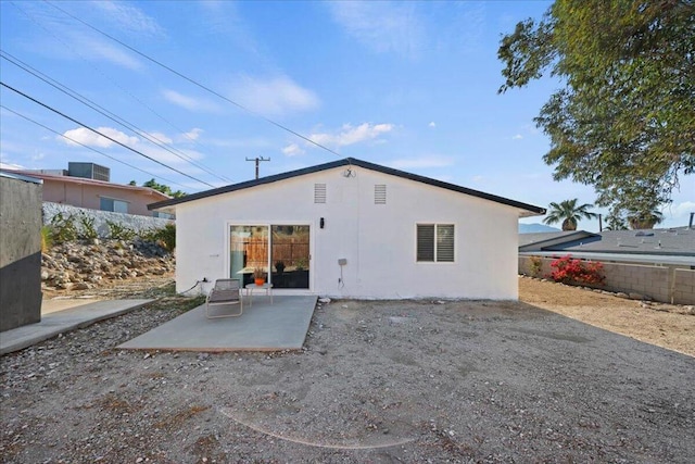 back of property with a patio