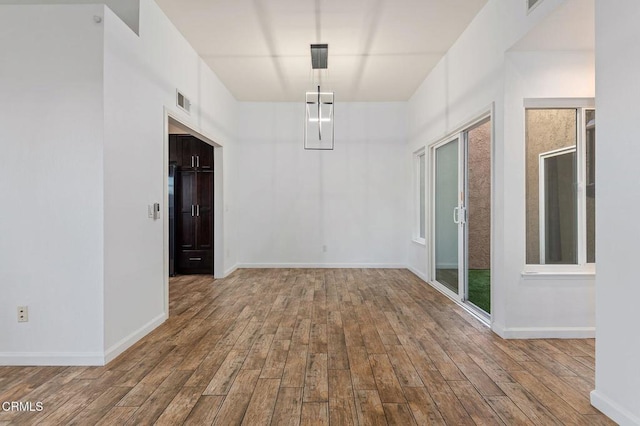 unfurnished room with hardwood / wood-style flooring