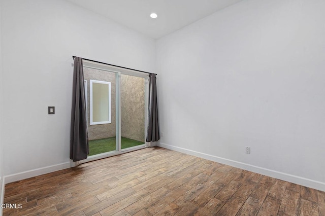 unfurnished room with hardwood / wood-style floors