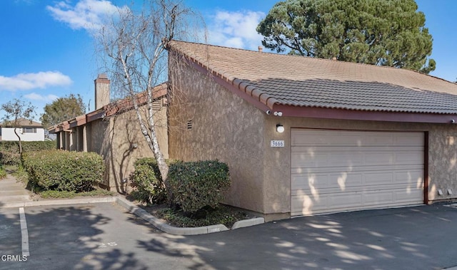 view of side of home featuring a garage