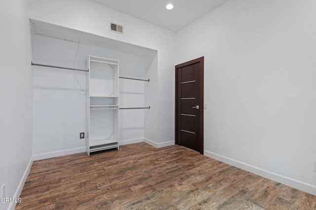 unfurnished bedroom with dark wood-type flooring