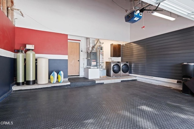 garage with washer and dryer, heating unit, and a garage door opener