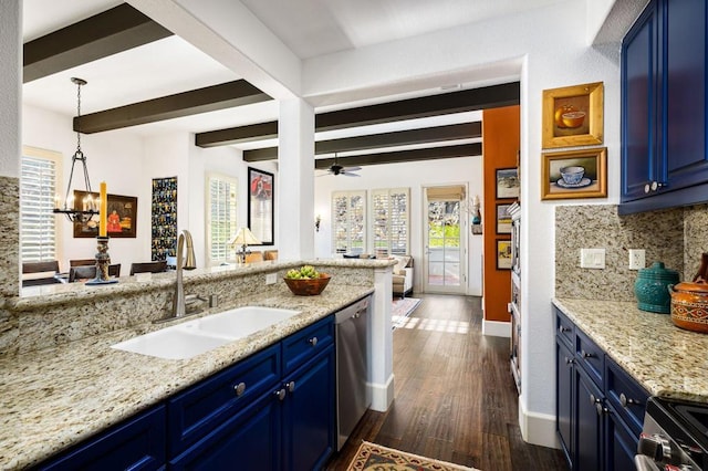 kitchen featuring backsplash, ceiling fan with notable chandelier, sink, and blue cabinetry