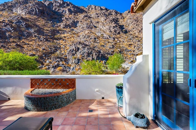 exterior space with a mountain view and a balcony