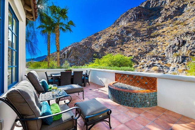 view of patio / terrace featuring a mountain view and a balcony