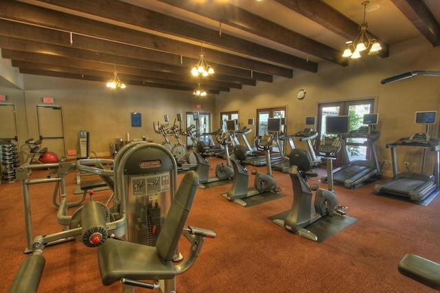 workout area featuring a chandelier and carpet flooring