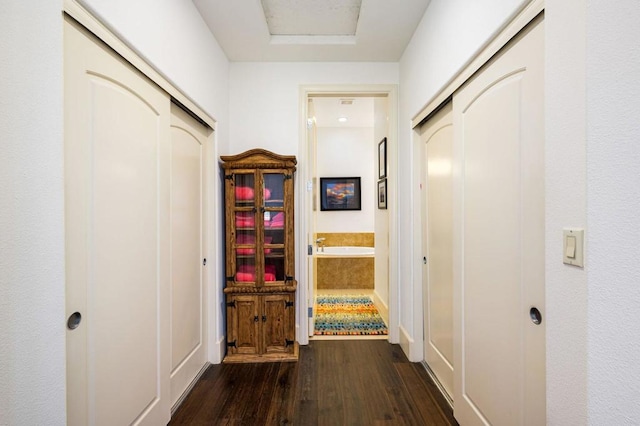 hall with dark hardwood / wood-style floors