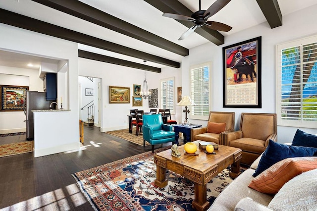 living room featuring dark wood-type flooring, a wealth of natural light, and beam ceiling