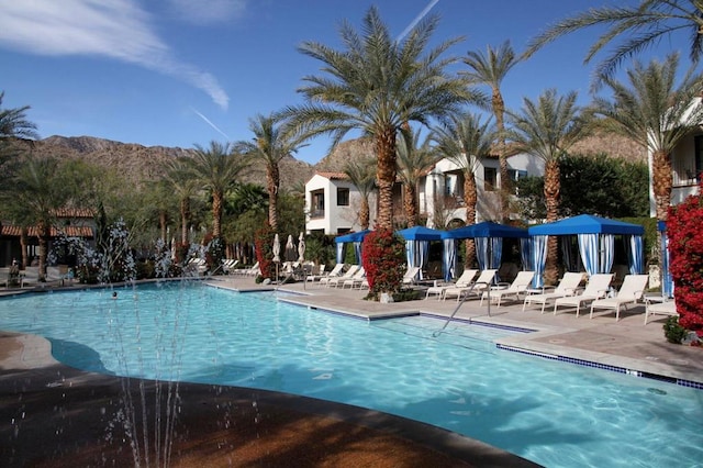 view of swimming pool with a patio area and a mountain view