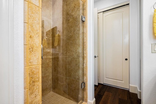 bathroom featuring wood-type flooring and walk in shower