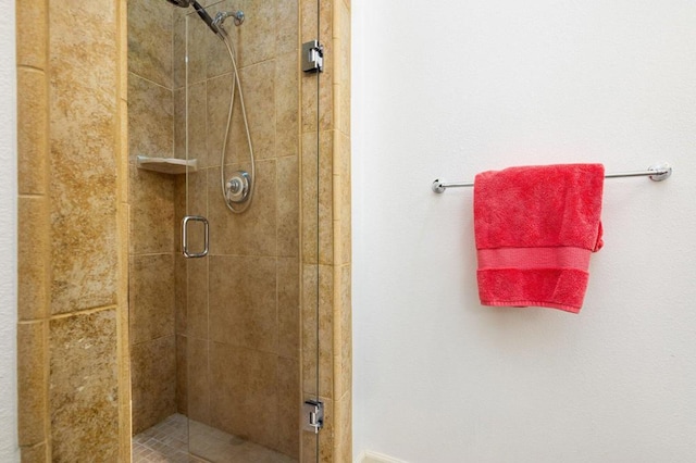 bathroom with a shower with door