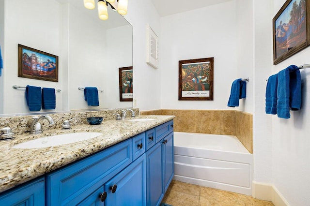 bathroom with vanity, a bathtub, and tile patterned floors