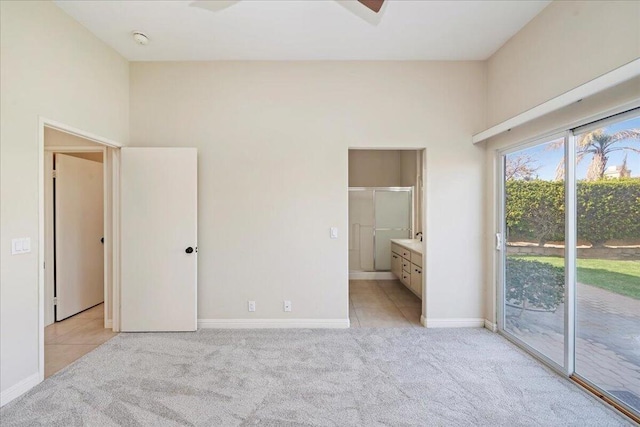 unfurnished bedroom featuring connected bathroom, access to exterior, and light colored carpet