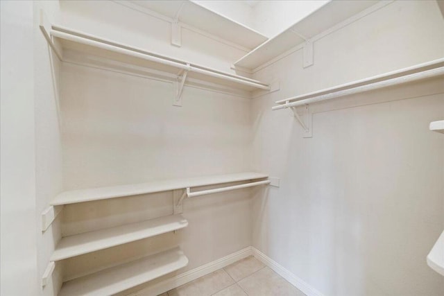 walk in closet featuring light tile patterned flooring