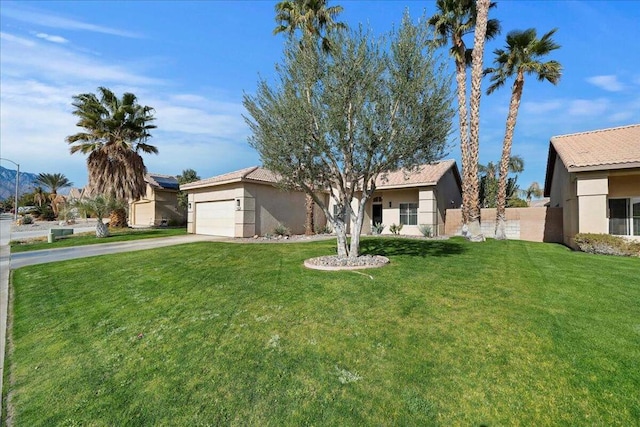 ranch-style house featuring a garage and a front yard