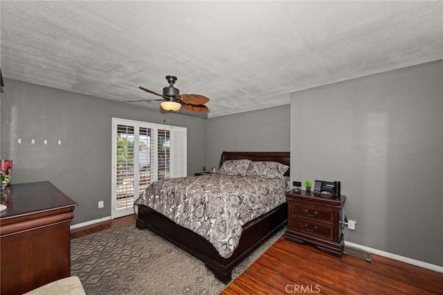 bedroom featuring ceiling fan, dark hardwood / wood-style floors, and a textured ceiling