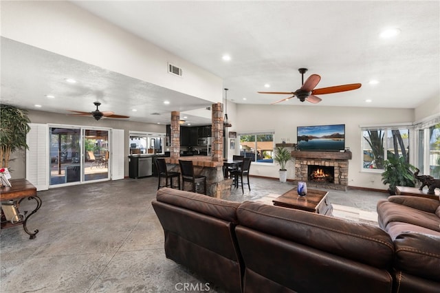 living room with vaulted ceiling, ceiling fan, and a wealth of natural light