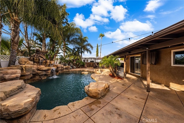 view of pool featuring pool water feature and a patio