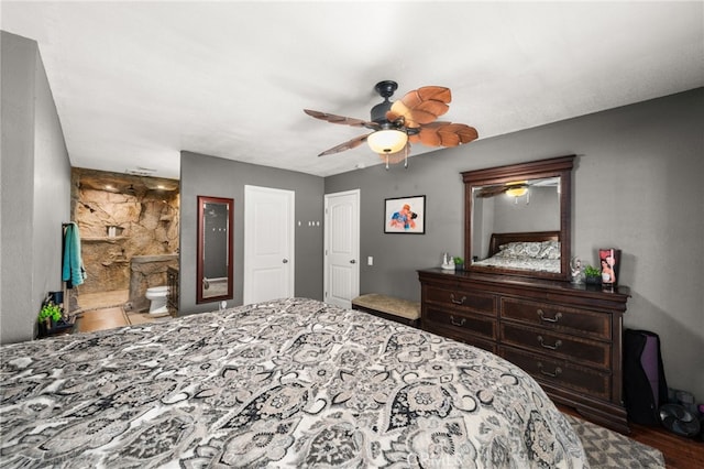 bedroom featuring ceiling fan and ensuite bath