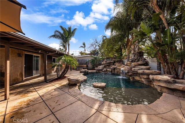 view of swimming pool featuring pool water feature and a patio