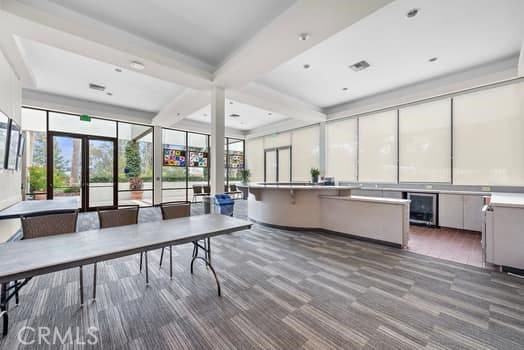 interior space featuring french doors, a wealth of natural light, and beamed ceiling