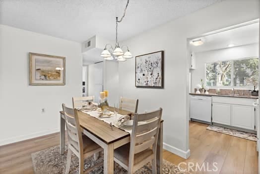 dining room featuring an inviting chandelier and light hardwood / wood-style flooring