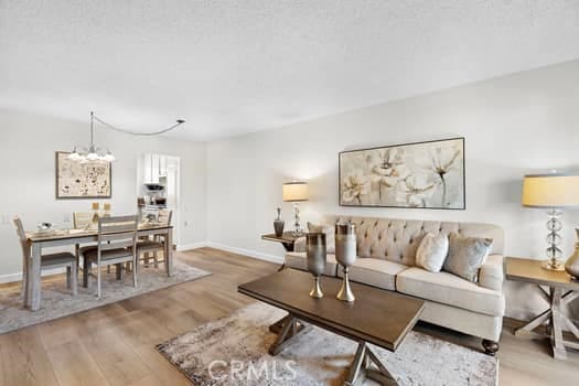 living room featuring a notable chandelier and light hardwood / wood-style floors