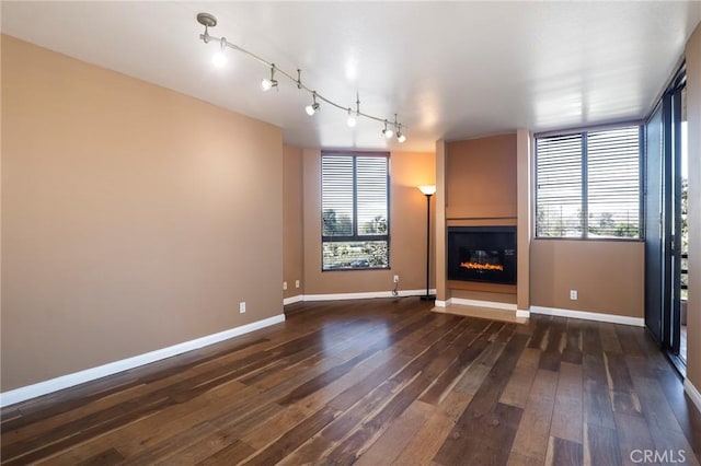 unfurnished living room with dark wood-type flooring