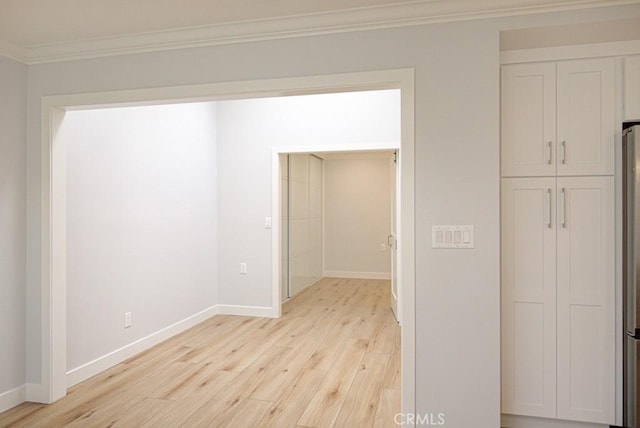 interior space with crown molding and light hardwood / wood-style flooring