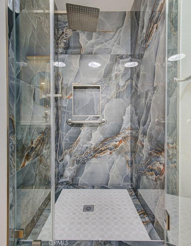 bathroom featuring a shower with door