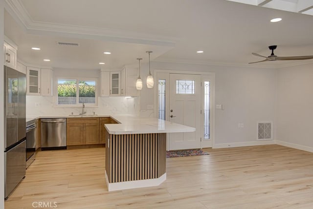 kitchen with tasteful backsplash, ceiling fan, pendant lighting, white cabinetry, and stainless steel appliances